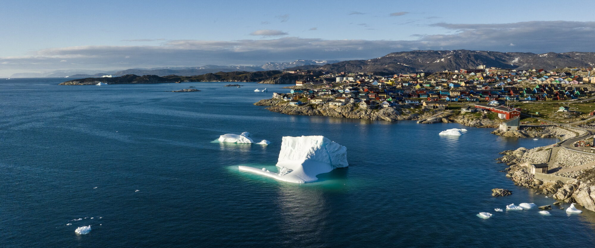 Ilulissat and an iceberg in the fjord