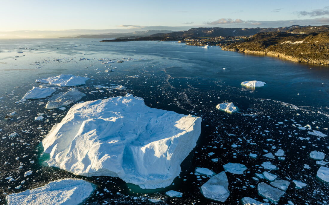An iceberg in the fjord, drift ice around it