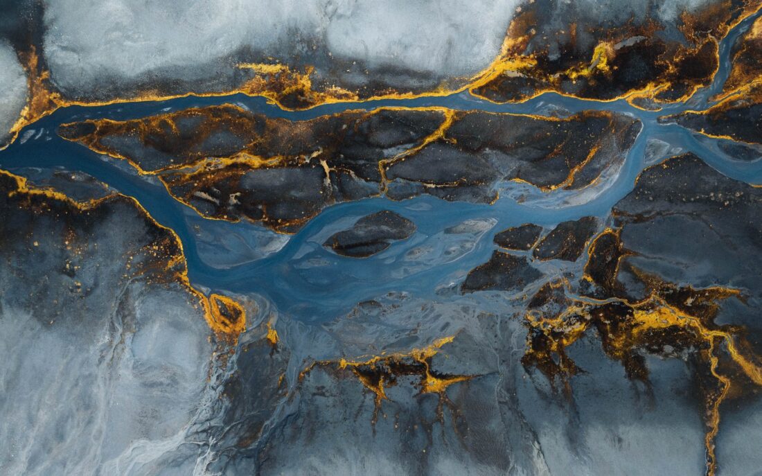 Braided river in the tundra from above, gold on grey