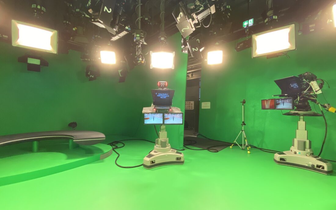 Green screen studio with lighting rig and camera